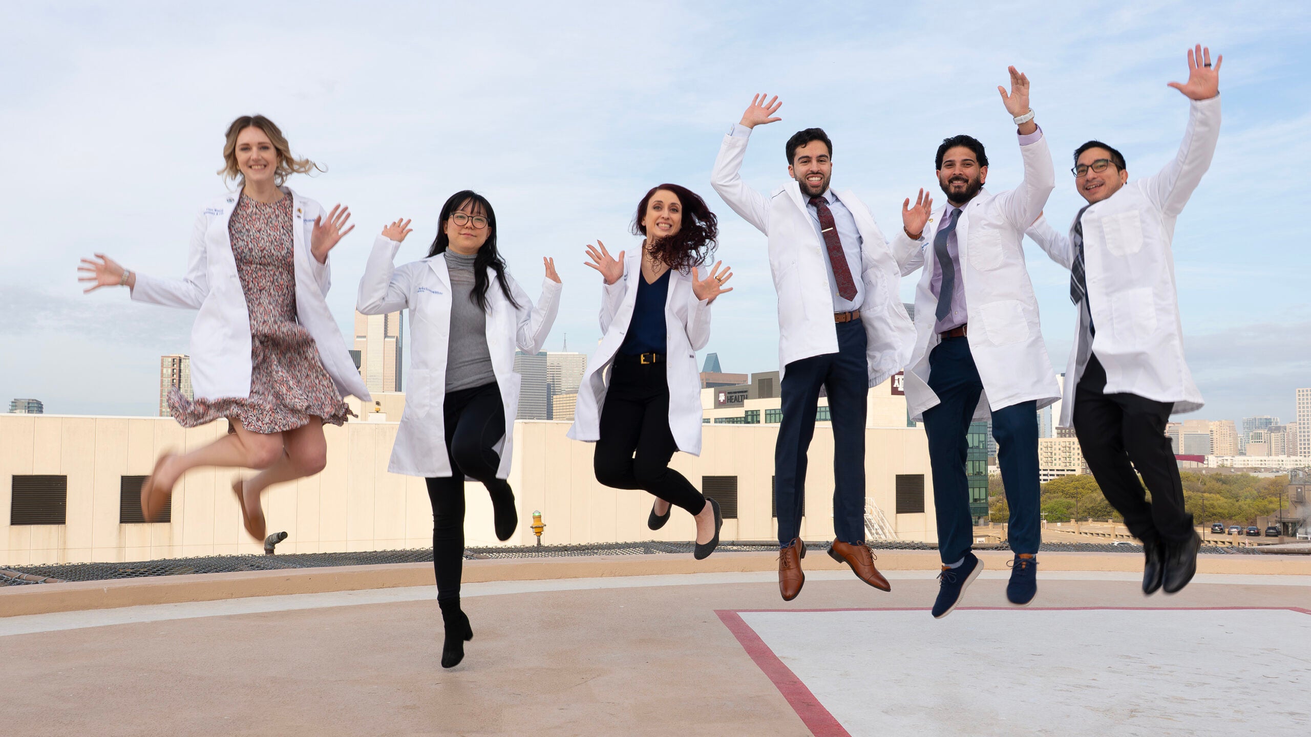 Pulmonary and Critical Care Medicine fellows at Baylor University Medical Center jumping in the air together to celebrate their fellowship training.
