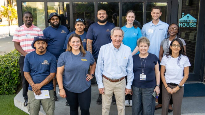 Photograph of volunteers from Baylor Scott & White and Sealy standing in front of Twice Blessed House.