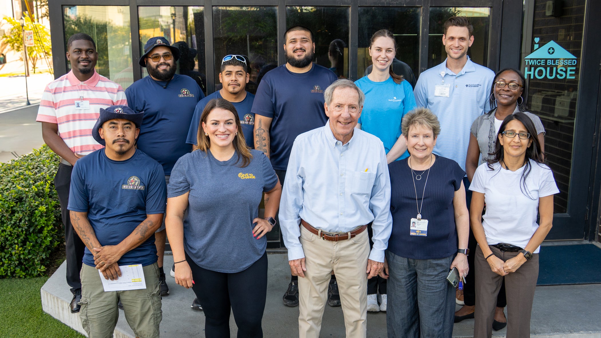 Photograph of volunteers from Baylor Scott & White and Sealy standing in front of Twice Blessed House.