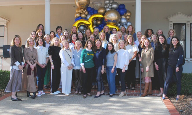 Members of The Crystal Charity Ball gathered in front of the future location of a new childcare center.