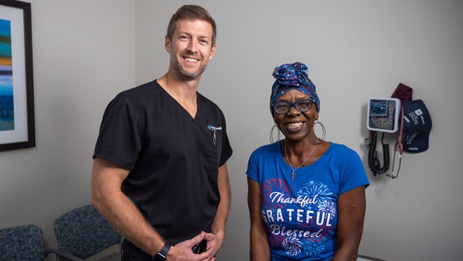 Physician standing with a patient at a Community Care Clinic